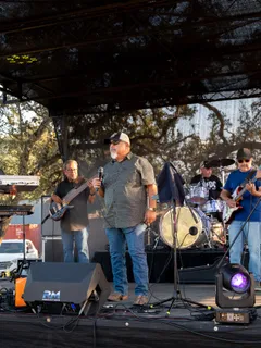A live band performing on stage at Paradise Live