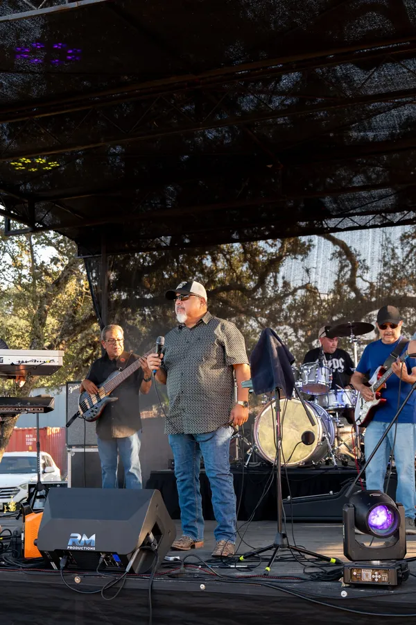 A live band performing on stage at Paradise Live
