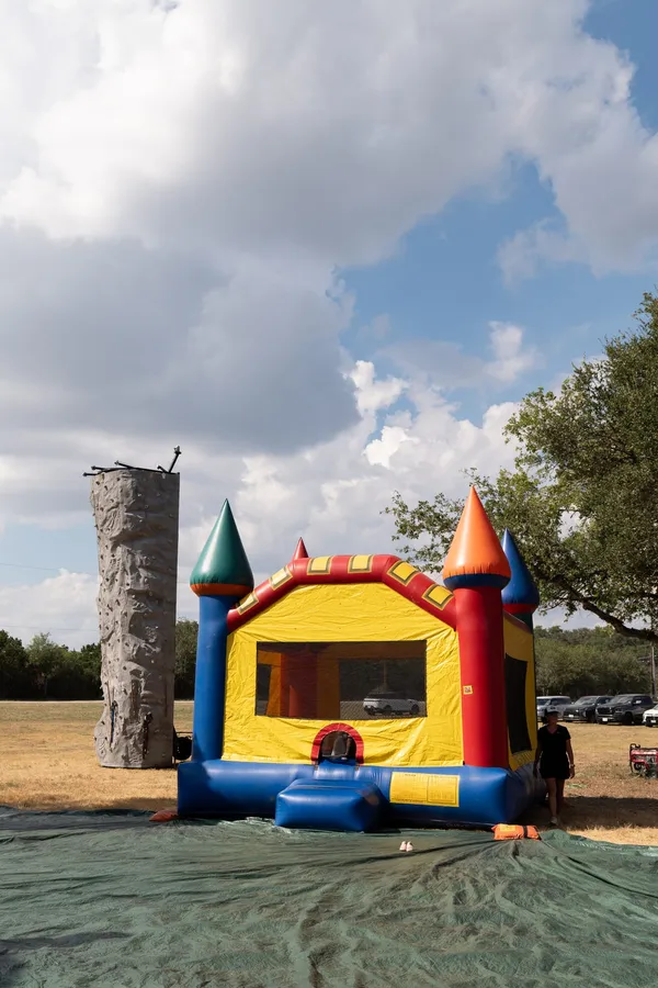 An inflatable bounce castle and rock climbing wall set up at Paradise Live