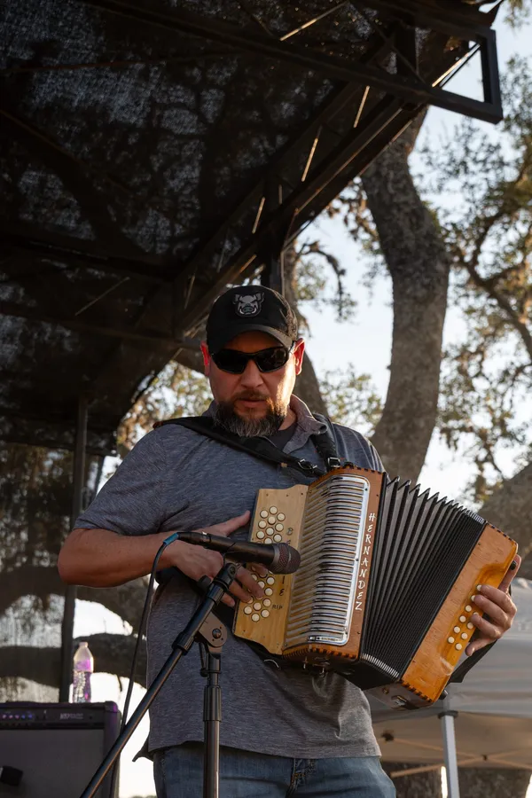 A musician playing accordion on stage at Paradise Live